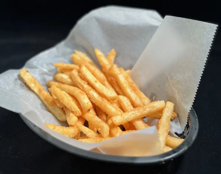 Fries Your Way: a paper-lined basket of seasoned fries.